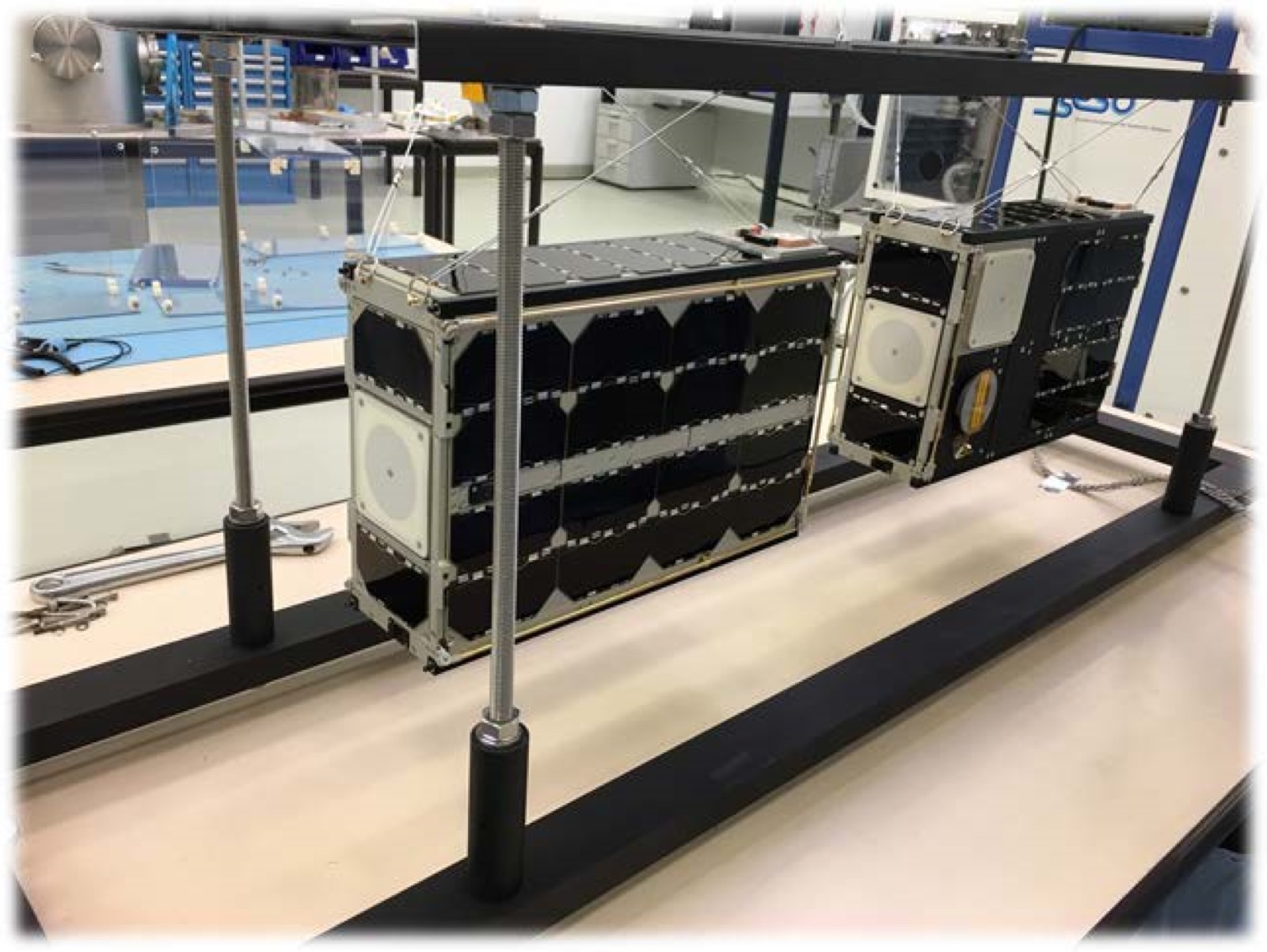 GOMX-4 pair suspended in a laboratory test rig at GomSpace.